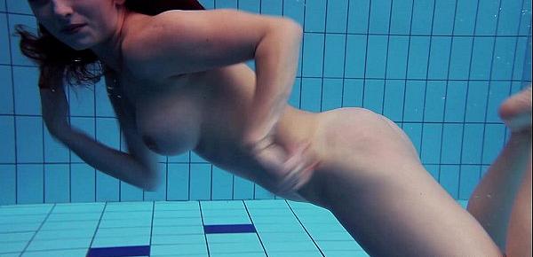  Redheaded Katrin is stripping underwater